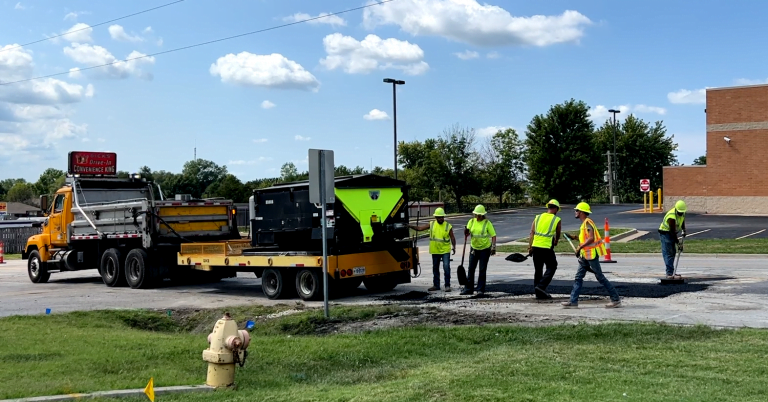 construction workers filling in the Sonic pothole