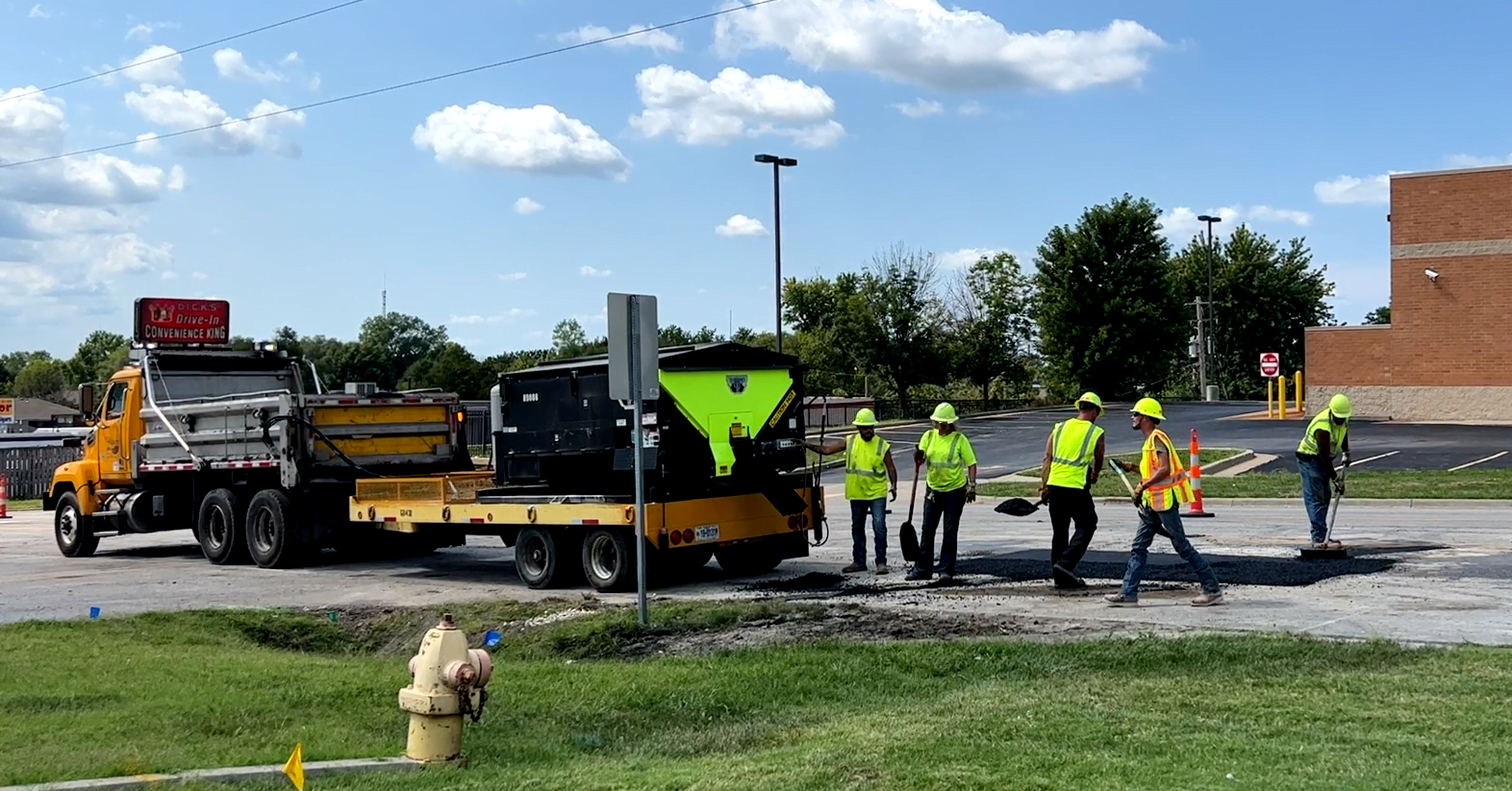 construction workers filling in the Sonic pothole