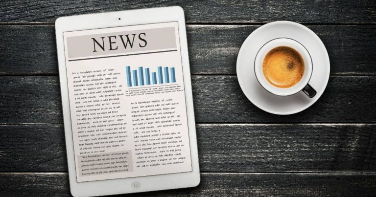 Digital News on a tablet with a cup of coffee