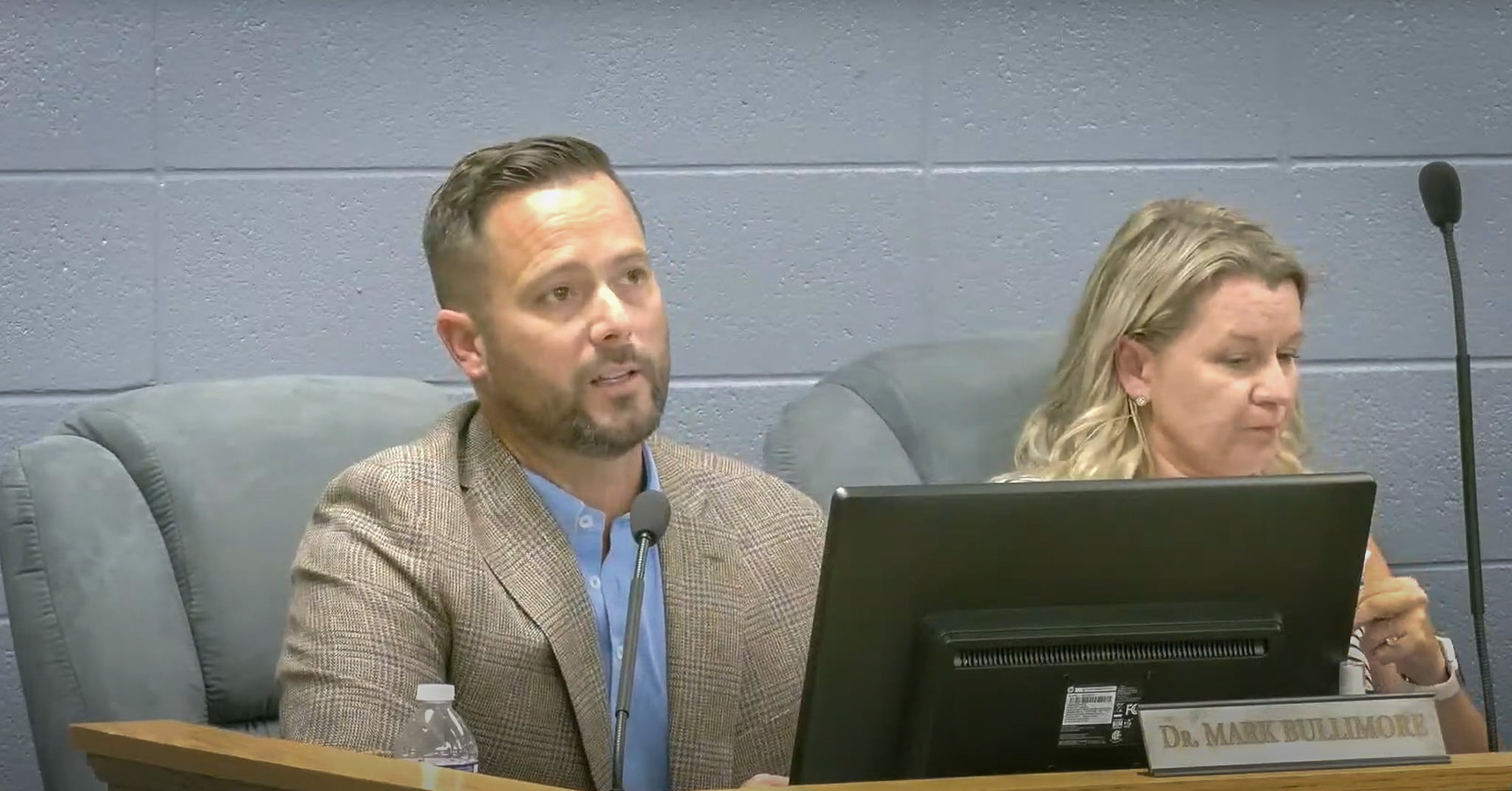 Dr Mark Bullimore speaks at a school board meeting