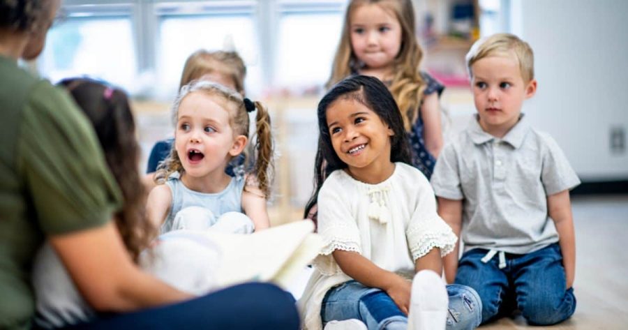 Toddlers gathered together on the floor for storytime