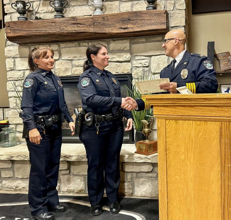 Officer Robertson and Officer Baxter receive a tenure service award from Chief Gregory Dull
