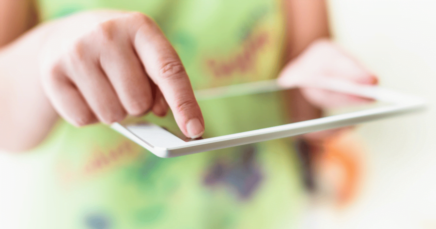 someone holding a tablet and clicking on something with their finger