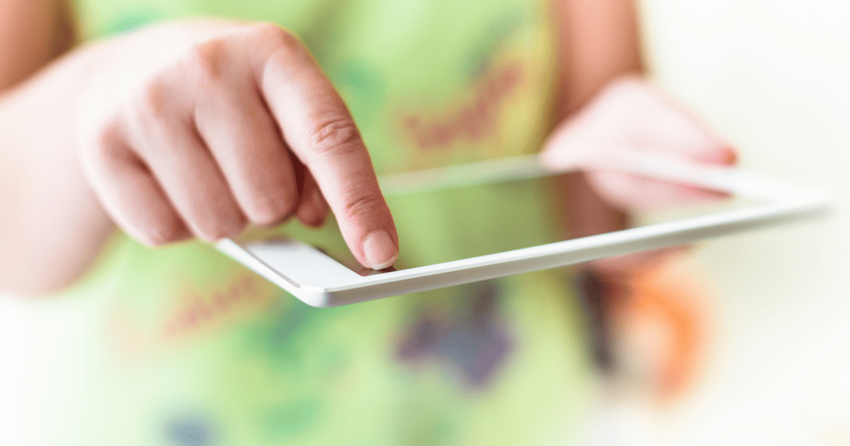 someone holding a tablet and clicking on something with their finger