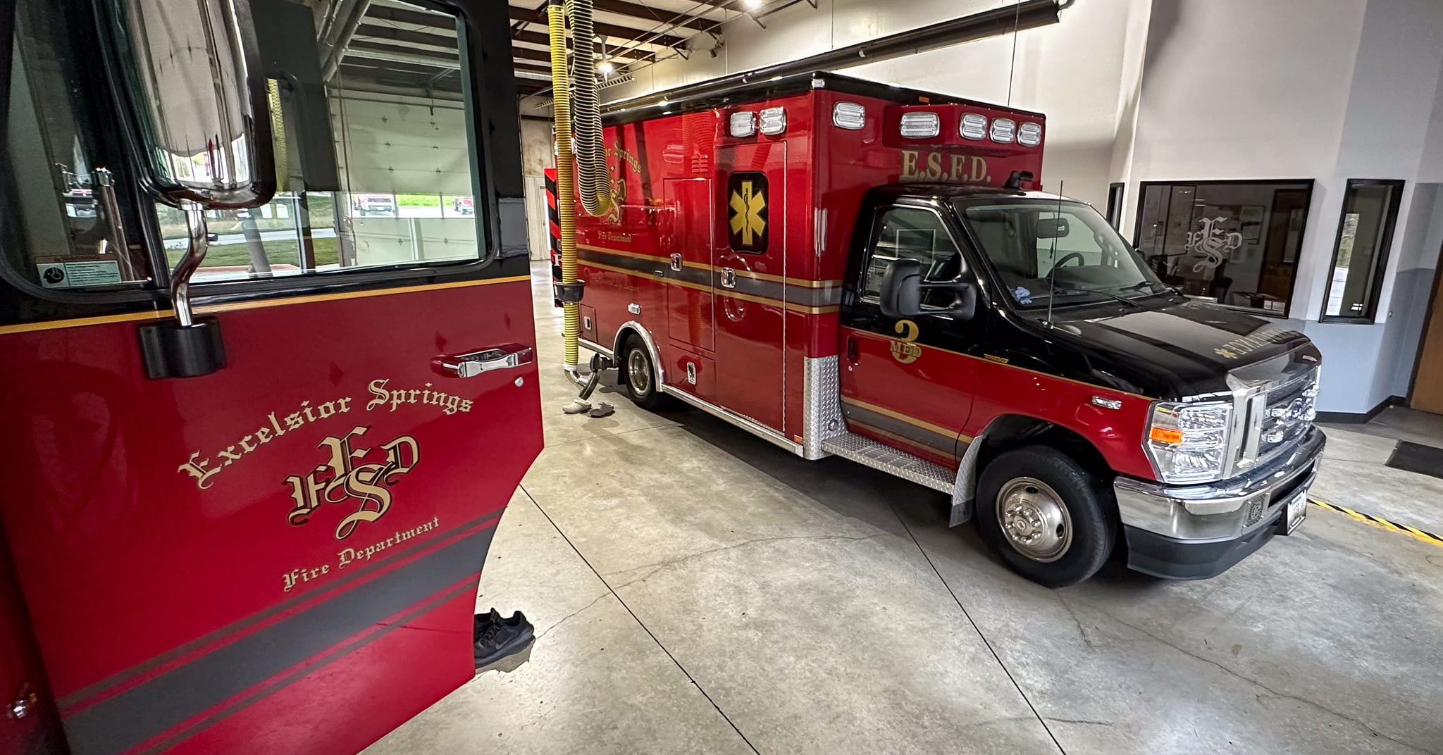 Excelsior Springs Fire Department ambulance and the door open on a fire truck
