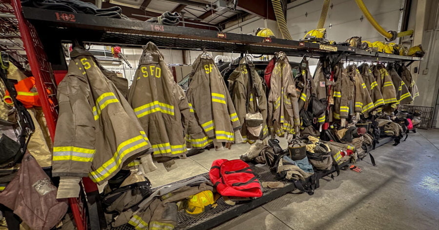 Excelsior Springs Fire Department firefighting jackets hung up ready to go in the garage