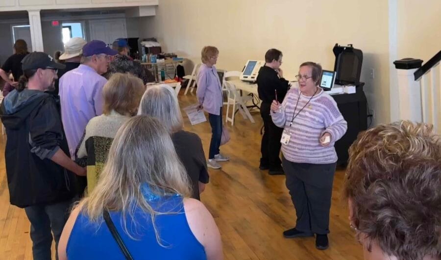Linda Gail, poll worker, educates the voters as they come into the poll