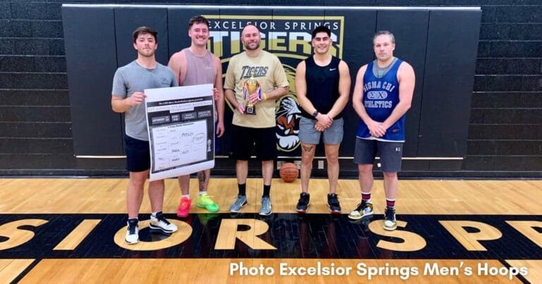 Alumni Team Phillips pose for a photo with their trophy
