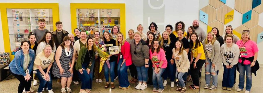 Staff at Cornerstone celebrate with Turner as she receives her Teacher of the Year award.