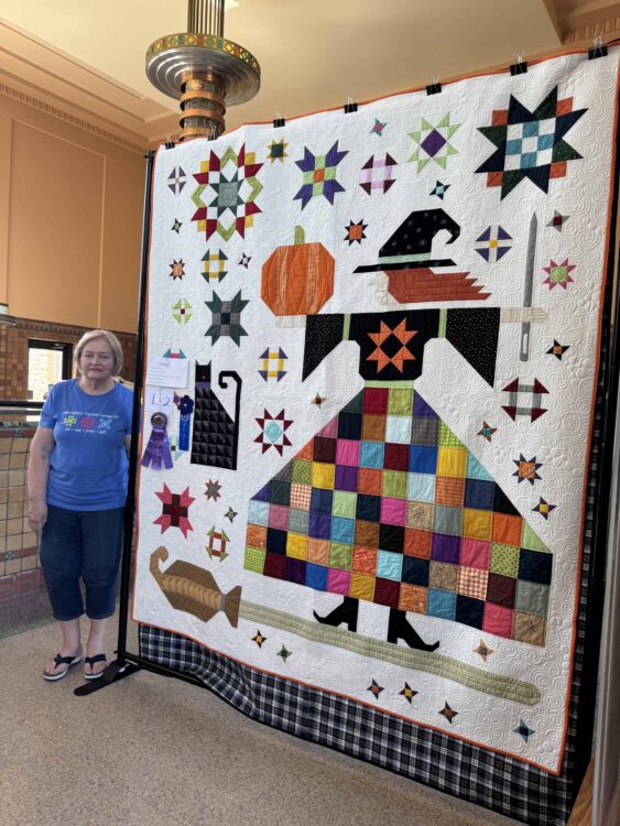 Trudy Gaines poses with her Best in Show quilt